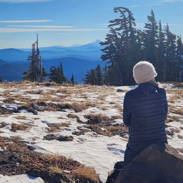 Woman enjoying mountain views in the winter